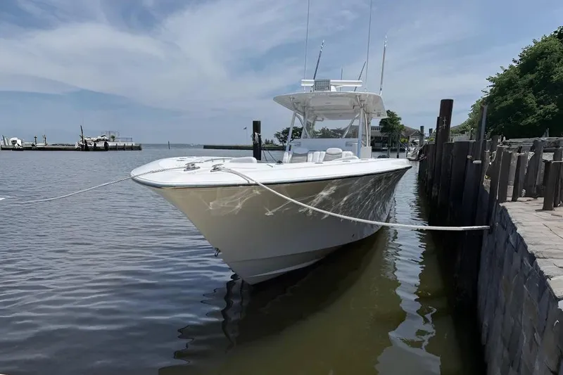  Yacht Photos Pics 2018 Invincible 42 Open Fisherman boat docked in a serene marina setting.