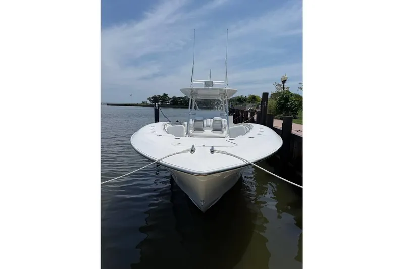  Yacht Photos Pics 2018 Invincible 42 Open Fisherman boat docked on calm water.