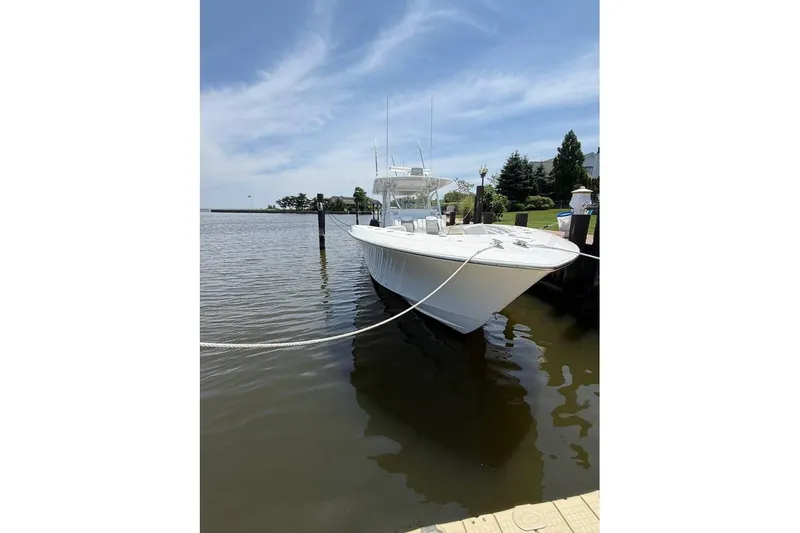  Yacht Photos Pics 2018 Invincible 42 Open Fisherman boat docked on a sunny day.