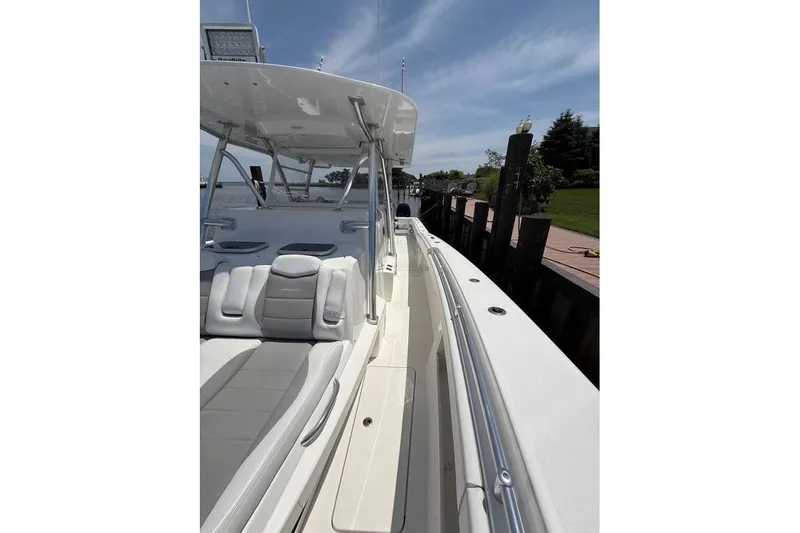  Yacht Photos Pics 2018 Invincible 42 Open Fisherman boat docked, featuring sleek design and comfortable seating.