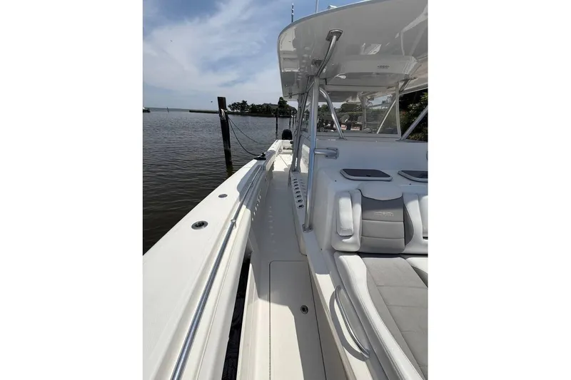  Yacht Photos Pics 2018 Invincible 42 Open Fisherman boat docked by the water.