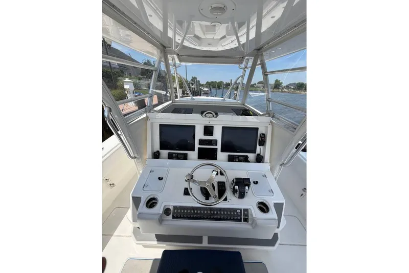  Yacht Photos Pics 2018 Invincible 42 Open Fisherman boat cockpit with navigation controls and screens.