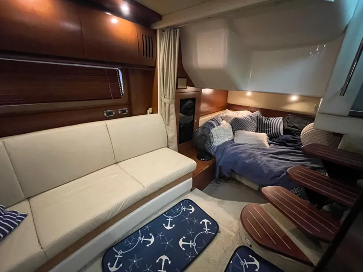  Yacht Photos Pics Interior of 2007 Sea Ray 38 Sundancer with sofa, bed, and nautical-themed decor.