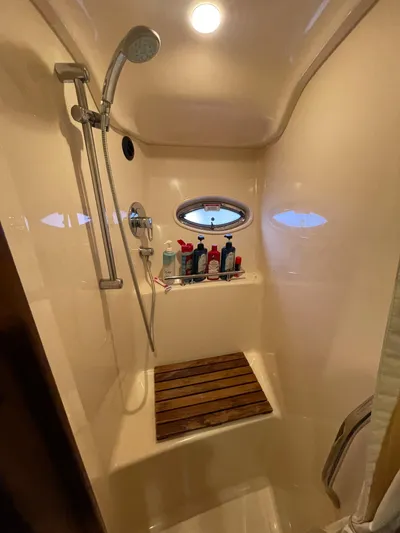  Yacht Photos Pics Shower area in 2007 Sea Ray 38 Sundancer yacht with wooden seat and porthole.