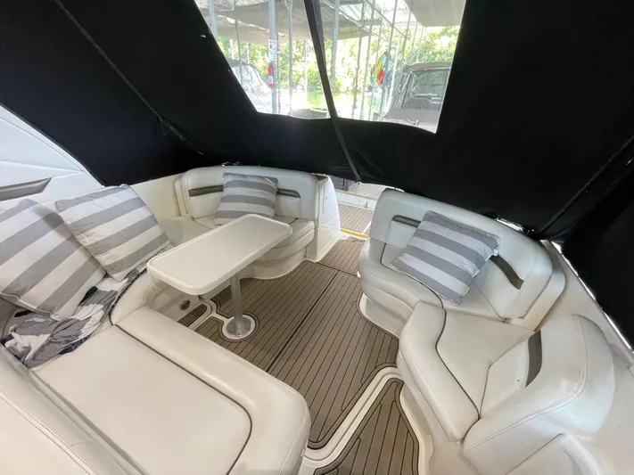  Yacht Photos Pics Interior seating area of 2007 Sea Ray 38 Sundancer with striped cushions and table.