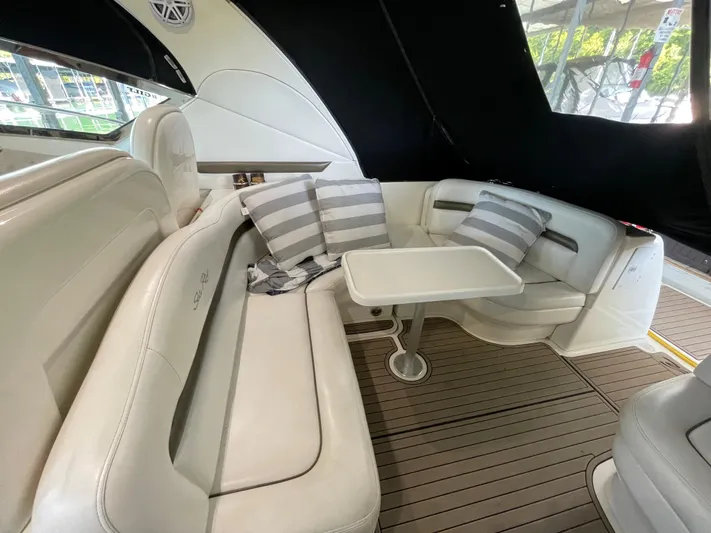  Yacht Photos Pics 2007 Sea Ray 38 Sundancer interior seating area with table and striped cushions.