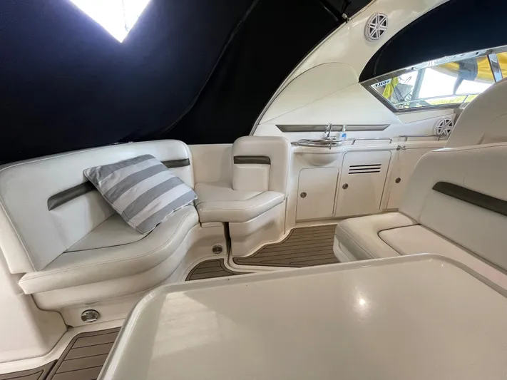  Yacht Photos Pics Interior of a 2007 Sea Ray 38 Sundancer yacht with white seating and striped pillow.