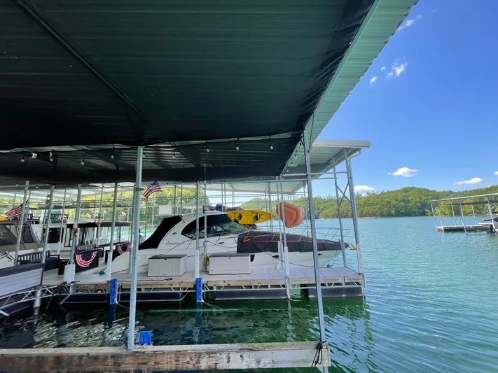  Yacht Photos Pics 2007 Sea Ray 38 Sundancer docked under a covered marina on a sunny day.