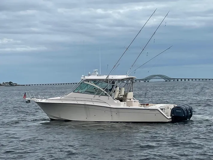  Yacht Photos Pics 2007 Grady-White Express 360 boat on water with fishing rods, bridge in background.