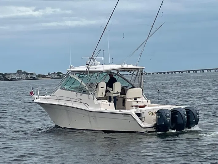  Yacht Photos Pics 2007 Grady-White Express 360 boat on water with fishing rods and outboard motors.