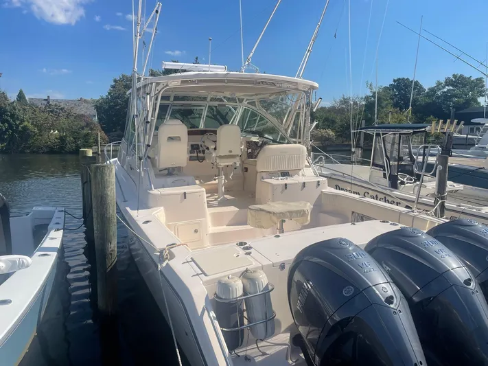  Yacht Photos Pics 2007 Grady-White Express 360 boat docked, featuring spacious cockpit and triple outboard engines.