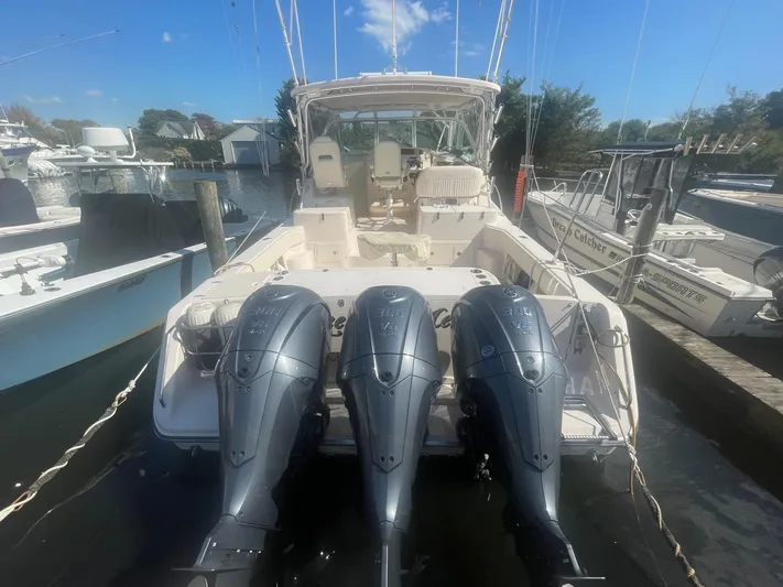  Yacht Photos Pics 2007 Grady-White Express 360 boat with triple outboard engines docked at a marina.