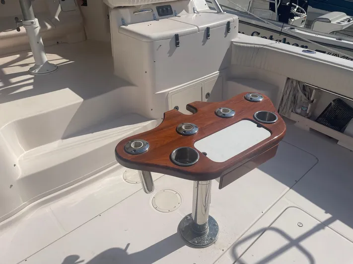  Yacht Photos Pics 2007 Grady-White Express 360 boat interior with wooden rod holder and seating area.
