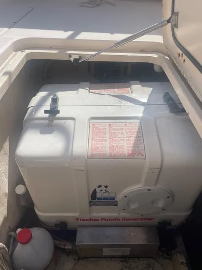  Yacht Photos Pics 2007 Grady-White Express 360 generator compartment with visible generator and storage area.