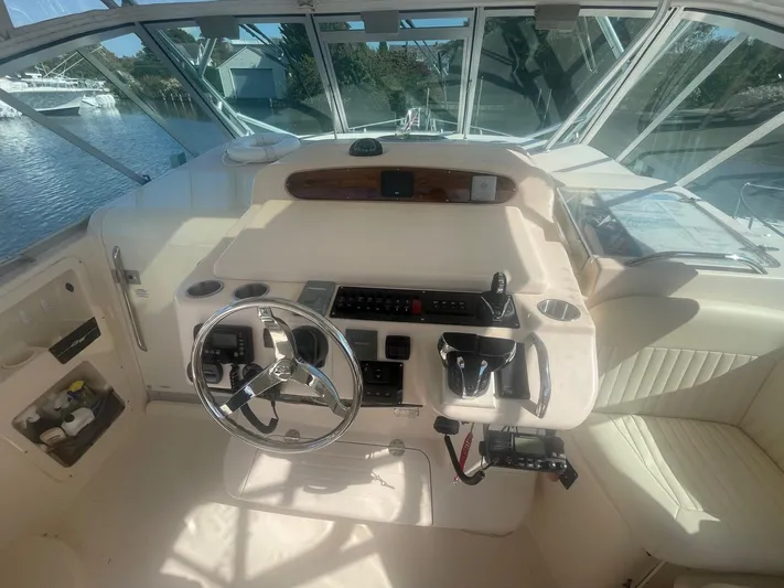  Yacht Photos Pics 2007 Grady-White Express 360 helm with steering wheel and control panel, docked by the water.