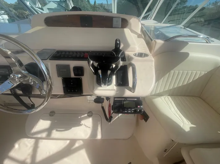  Yacht Photos Pics 2007 Grady-White Express 360 helm with steering wheel and controls, featuring beige interior.