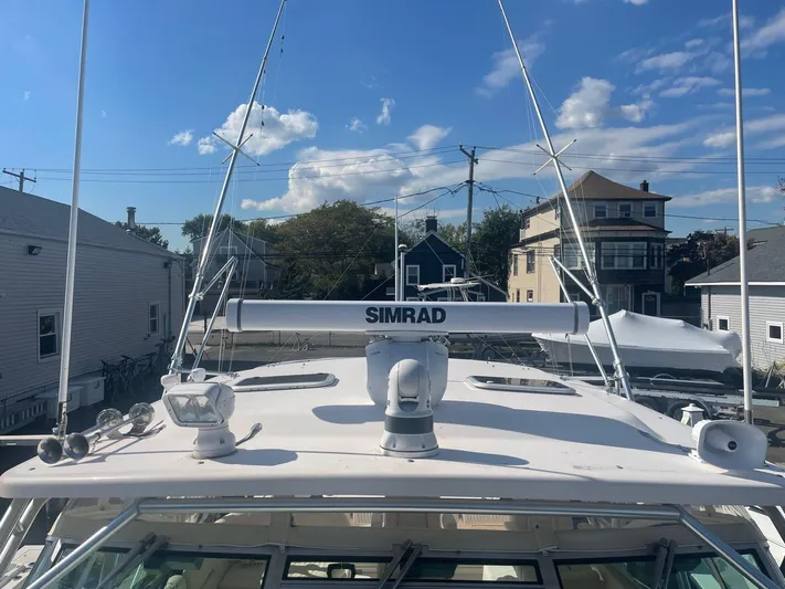  Yacht Photos Pics 2007 Grady-White Express 360 boat with Simrad radar, docked under a clear blue sky.