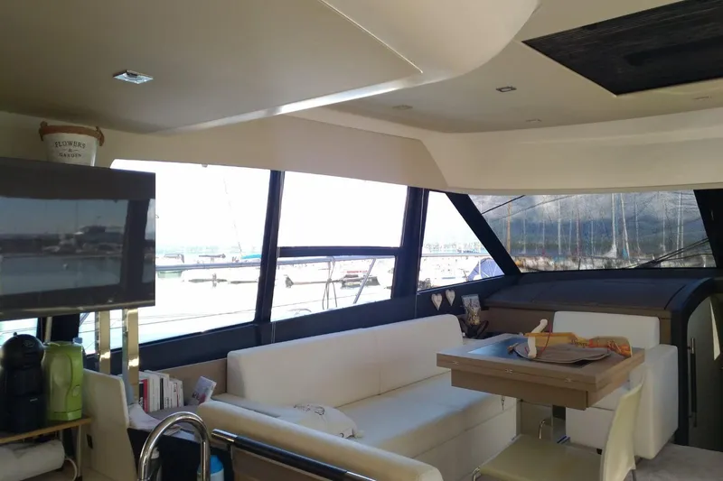  Yacht Photos Pics Interior of 2016 Prestige 550 yacht with modern seating and large windows.