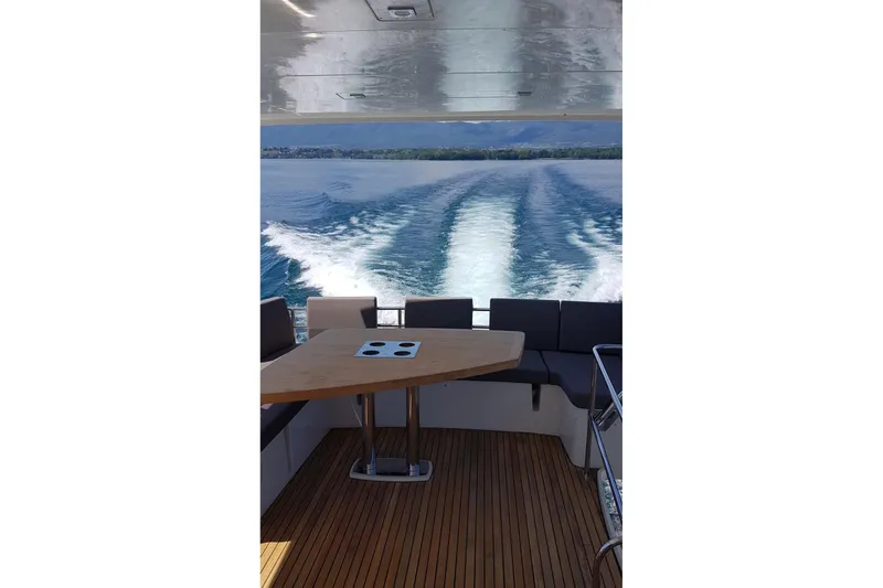  Yacht Photos Pics Prestige 550 yacht interior with wooden deck, ocean view, and seating area, 2016 model.