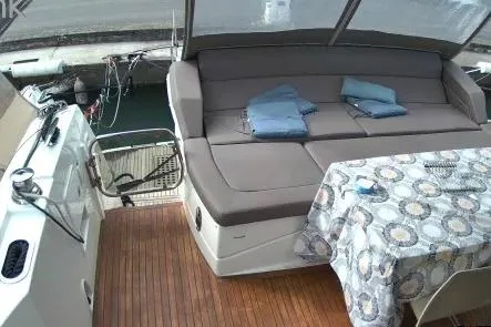  Yacht Photos Pics 2016 Prestige 550 yacht deck with seating, table, and folded towels.