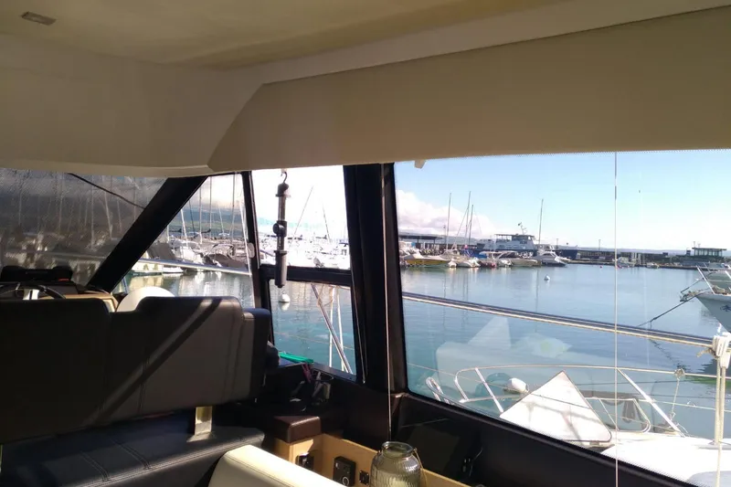  Yacht Photos Pics Interior view of 2016 Prestige 550 yacht overlooking marina with boats.