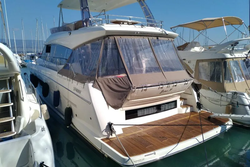  Yacht Photos Pics Luxury 2016 Prestige 550 yacht docked at marina, featuring elegant design and spacious deck.