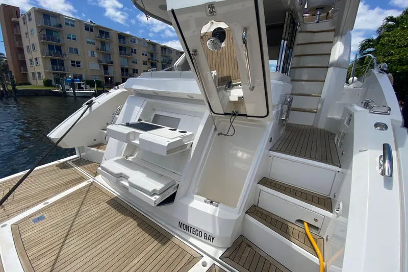 Gaia Yacht Photos Pics 2017 Sunseeker Manhattan 52 yacht with teak deck and modern amenities, docked near waterfront buildings.
