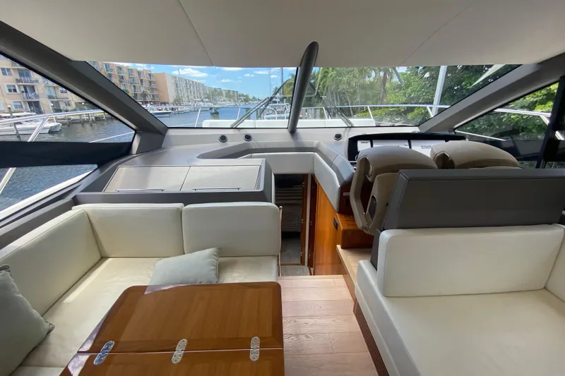 Gaia Yacht Photos Pics Luxurious interior of 2017 Sunseeker Manhattan 52 yacht with elegant seating and helm.