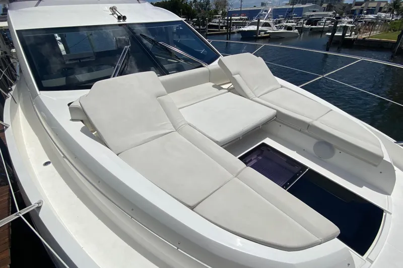 Gaia Yacht Photos Pics 2017 Sunseeker Manhattan 52 yacht with luxurious sunbathing area, docked at marina.