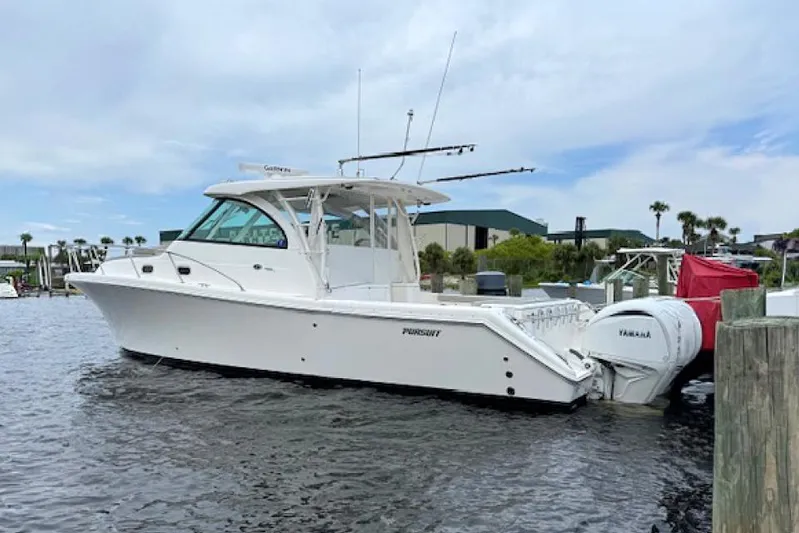 Nothing But Fine Yacht Photos Pics 2022 Pursuit OS 385 Offshore boat docked with Yamaha engines, under a partly cloudy sky.