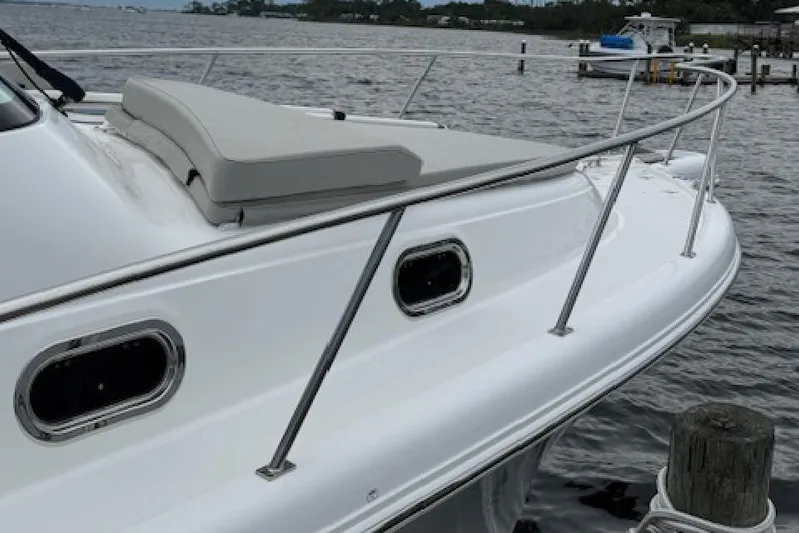 Nothing But Fine Yacht Photos Pics 2022 Pursuit OS 385 Offshore boat docked by the water.