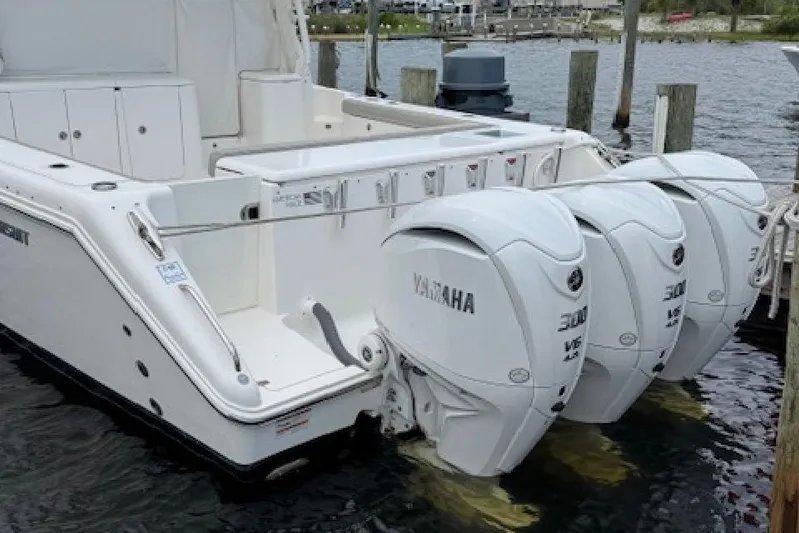 Nothing But Fine Yacht Photos Pics 2022 Pursuit OS 385 Offshore boat with triple Yamaha outboard engines docked.