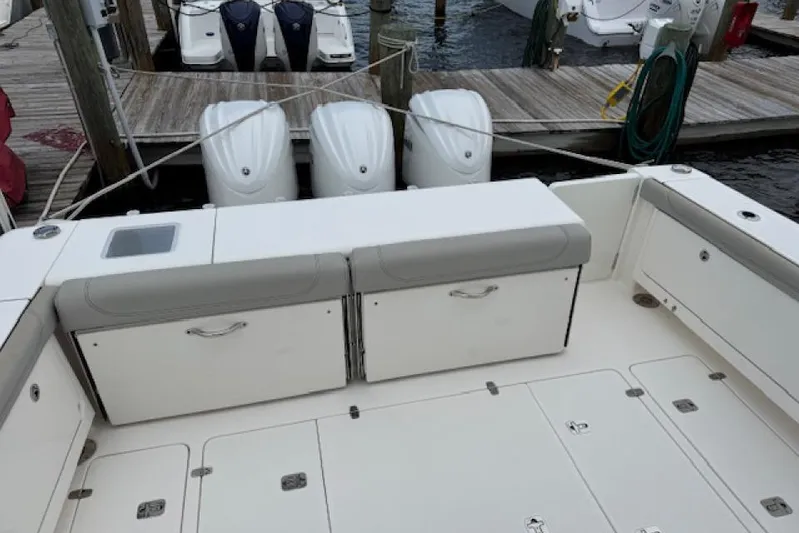 Nothing But Fine Yacht Photos Pics 2022 Pursuit OS 385 Offshore boat with triple outboard engines at dock.