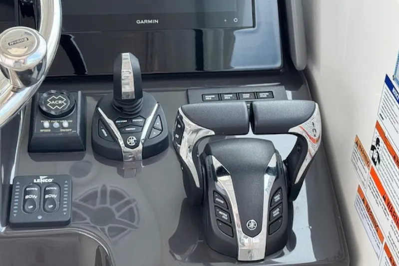 Nothing But Fine Yacht Photos Pics Control panel of 2022 Pursuit OS 385 Offshore boat with steering and throttle controls.