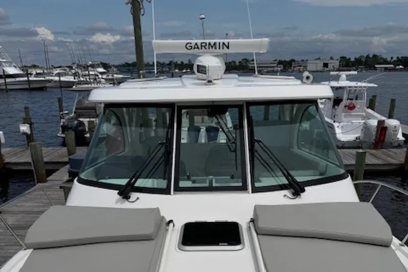 Nothing But Fine Yacht Photos Pics 2022 Pursuit OS 385 Offshore boat docked at marina with Garmin equipment.