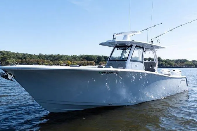  Yacht Photos Pics 2024 Sportsman Open 322 Center Console boat on calm water, side view.