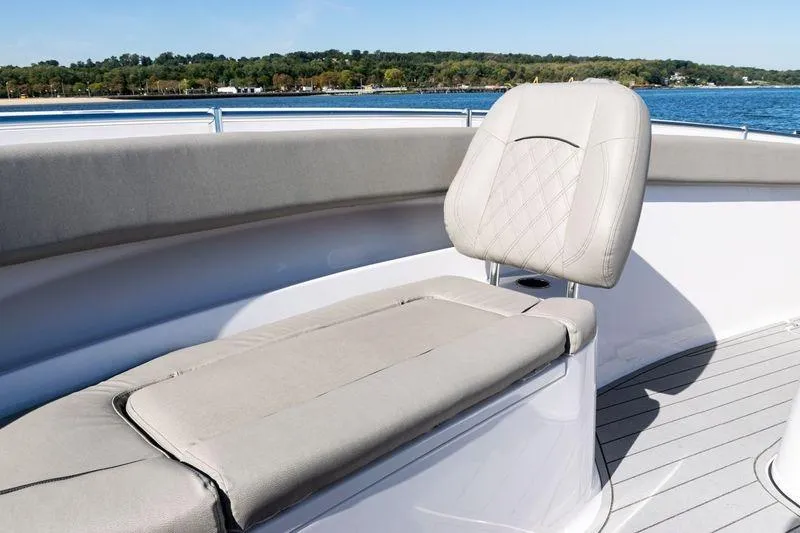  Yacht Photos Pics 2024 Sportsman Open 322 Center Console boat with cushioned seating, on a sunny day.