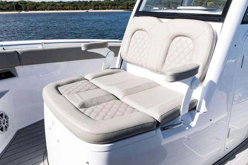  Yacht Photos Pics 2024 Sportsman Open 322 Center Console boat seating with luxurious upholstery and scenic water backdrop.