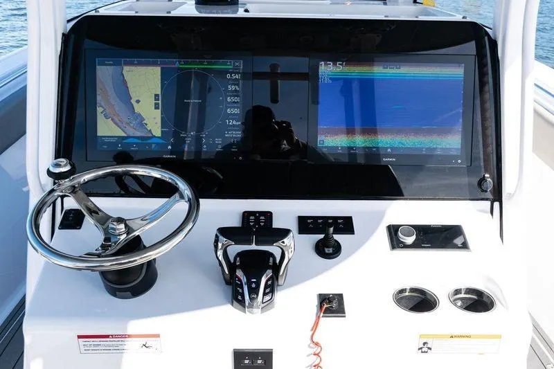  Yacht Photos Pics 2024 Sportsman Open 322 Center Console dashboard with navigation screens and controls.