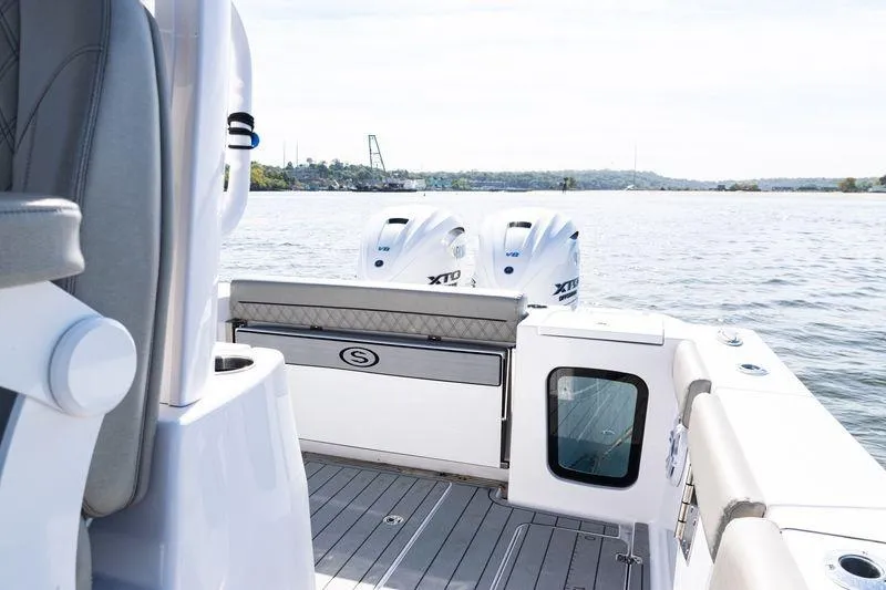  Yacht Photos Pics 2024 Sportsman Open 322 Center Console boat on water, featuring dual engines.