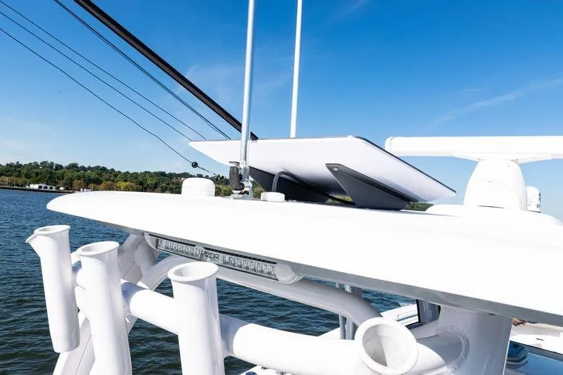  Yacht Photos Pics 2024 Sportsman Open 322 Center Console boat detail with rod holders and radar, on a sunny day.