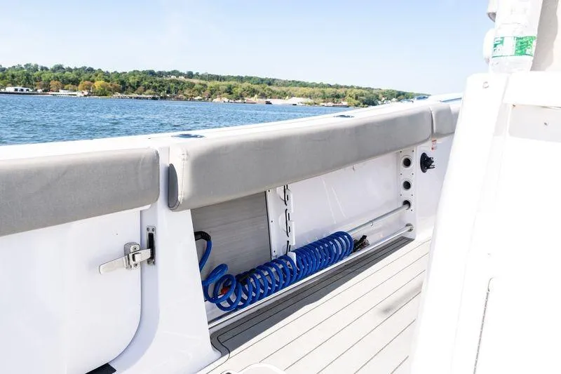  Yacht Photos Pics 2024 Sportsman Open 322 Center Console boat interior with coiled blue hose.