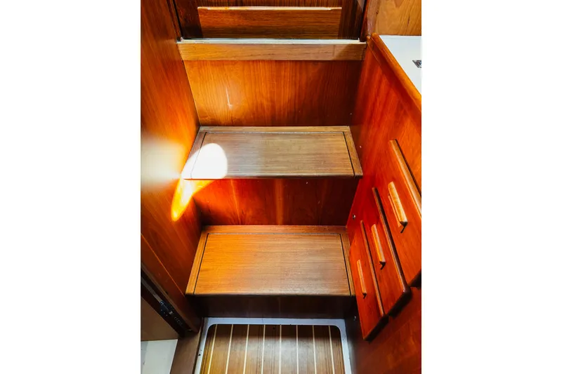 Maverick Yacht Photos Pics Wooden interior stairs of 2012 Hinckley Picnic Boat MKIII, featuring warm tones and cabinetry.
