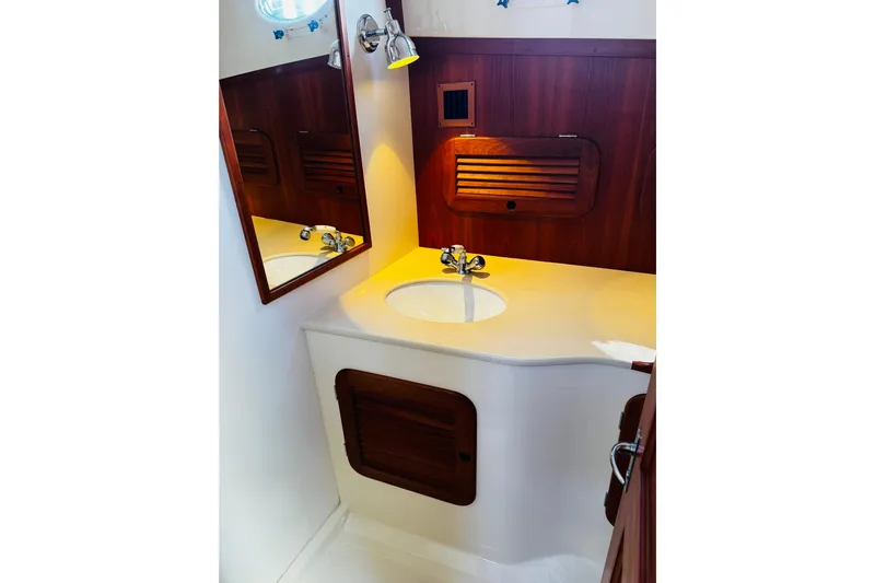 Maverick Yacht Photos Pics Hinckley Picnic Boat MKIII 2012 bathroom with wooden accents and modern sink design.