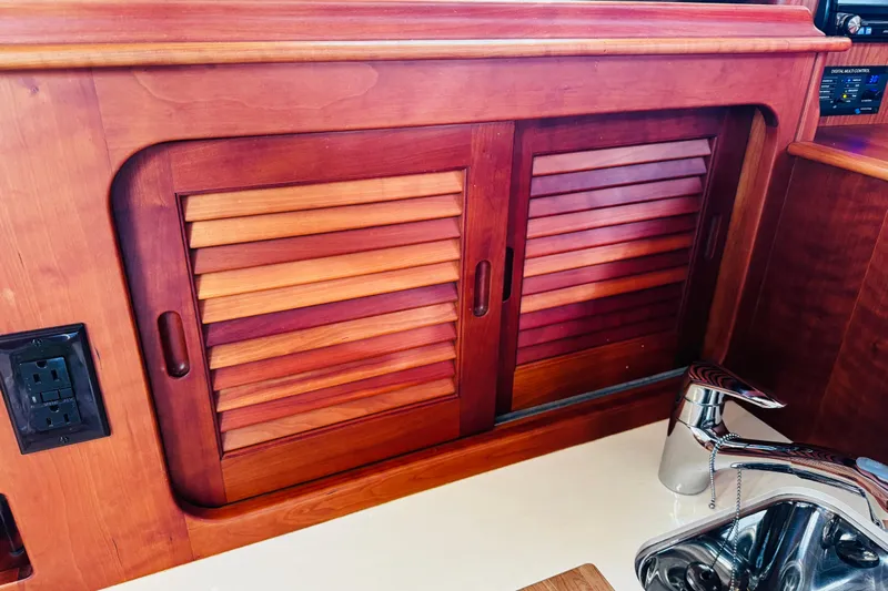 Maverick Yacht Photos Pics Hinckley Picnic Boat MKIII 2012 interior with wooden cabinet and stainless steel sink.
