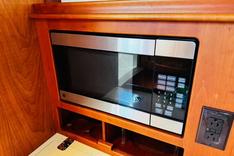 Maverick Yacht Photos Pics Built-in microwave in 2012 Hinckley Picnic Boat MKIII with wooden cabinetry.