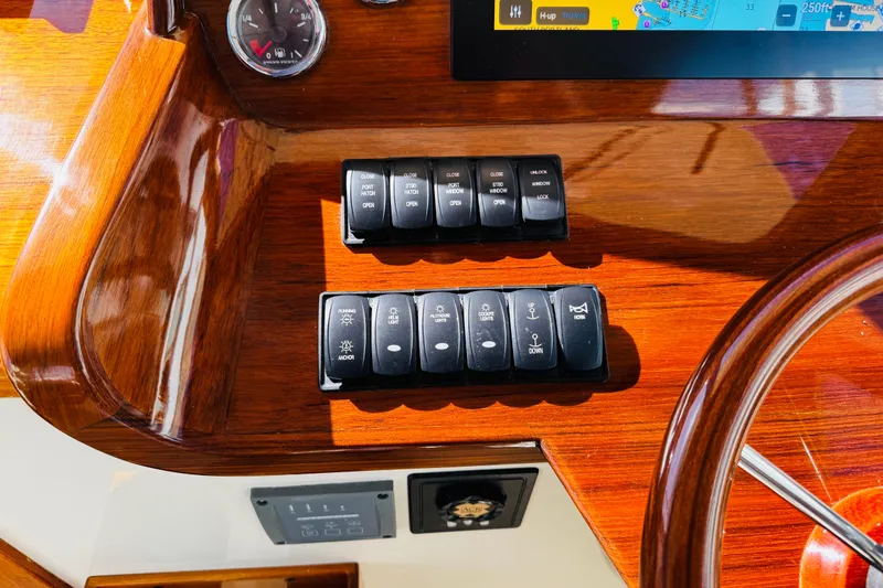 Maverick Yacht Photos Pics Control panel of a 2012 Hinckley Picnic Boat MKIII with switches and navigation display.