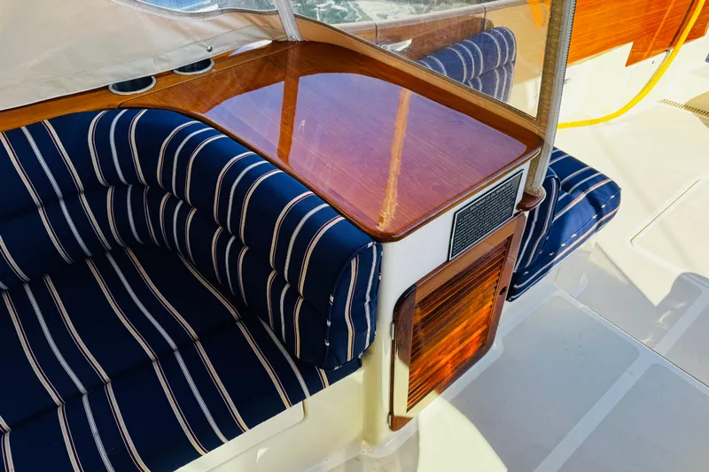 Maverick Yacht Photos Pics Luxurious interior of 2012 Hinckley Picnic Boat MKIII with striped seating and polished wood finish.