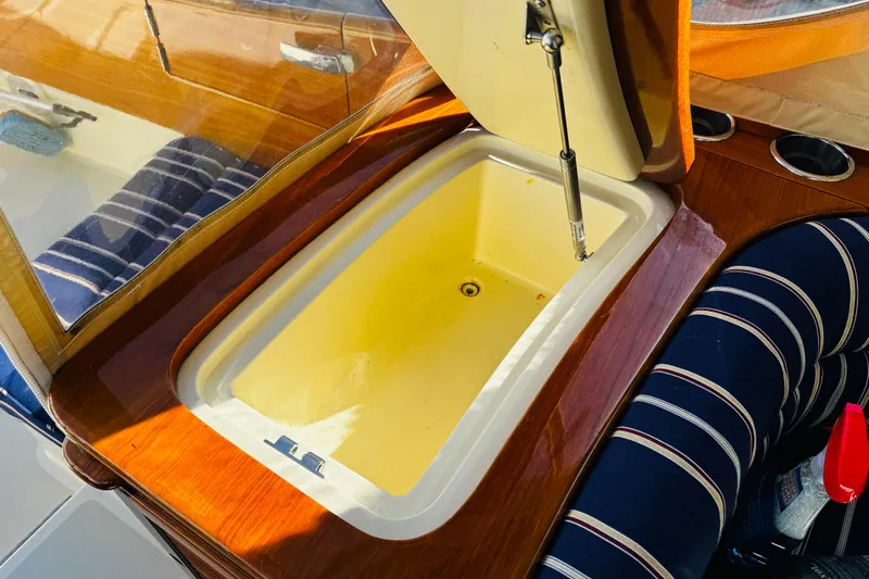 Maverick Yacht Photos Pics Hinckley Picnic Boat MKIII 2012 interior with open storage compartment and striped seating.
