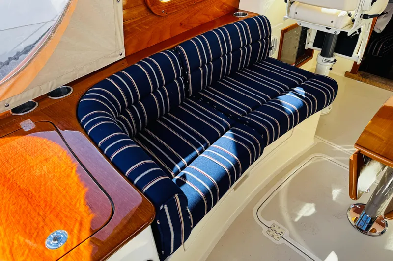 Maverick Yacht Photos Pics 2012 Hinckley Picnic Boat MKIII interior with striped seating and wooden accents.